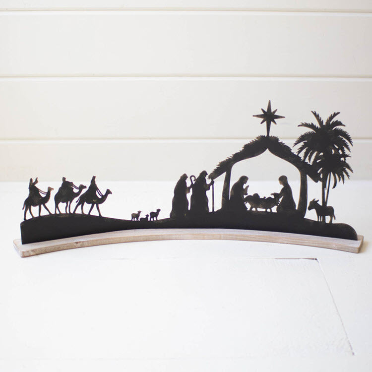 Black Metal Nativity on a Curved White Wood Base