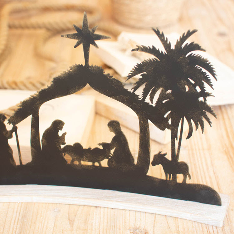 Black Metal Nativity on a Curved White Wood Base